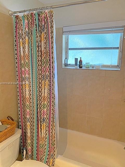 7580 Southwest 82nd Street, Unit F217 Miami, FL 33143 - Photo 7 of 14 a bathroom with a bathtub and shower