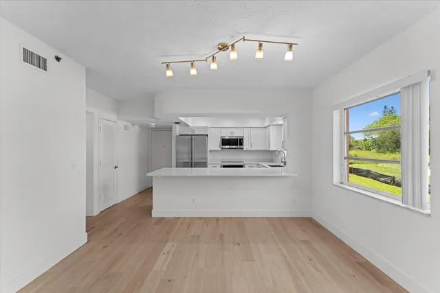 a view of kitchen with sink and wooden floor
