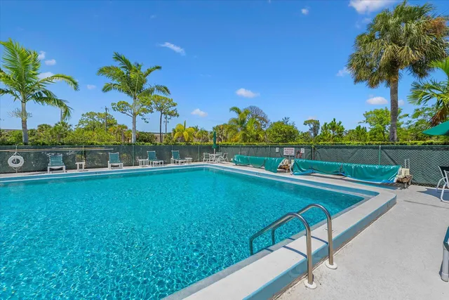 a view of a swimming pool with an outdoor seating and a garden