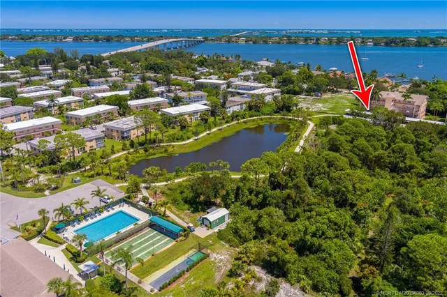 an aerial view of residential houses with outdoor space and swimming pool