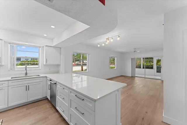 a large white kitchen with a window
