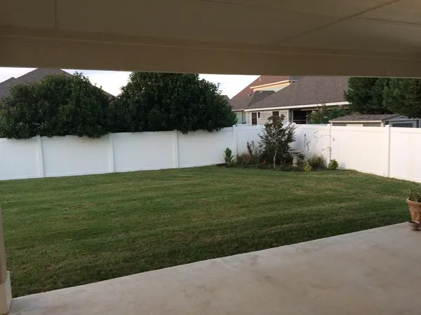 a view of a field of grass and trees