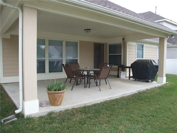 a view of a house with patio and garden
