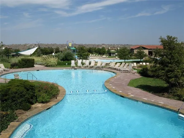 an aerial view of a house with a garden and lake view