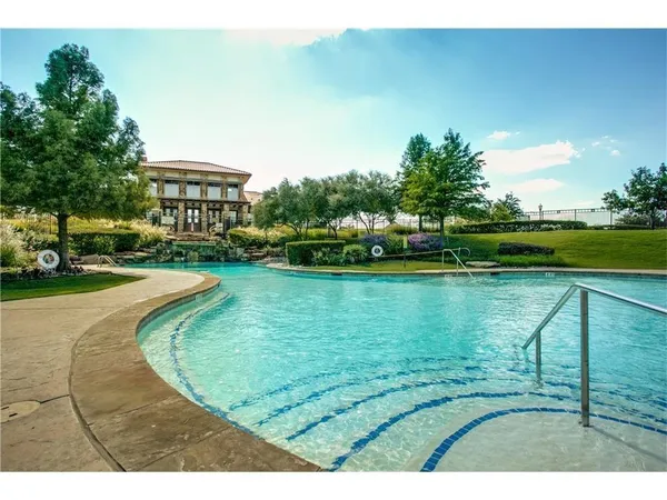 a view of a swimming pool with a yard