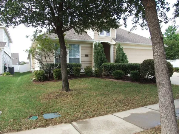 a view of a house with a backyard