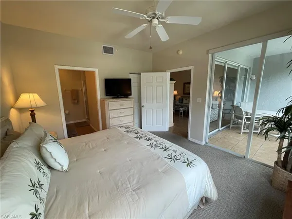 a bedroom with a bed and a flat tv screen
