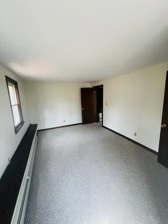 a view of an empty room and a stove