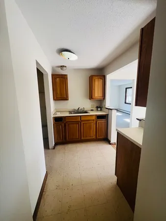 a view of kitchen with stainless steel appliances granite countertop refrigerator stove microwave and sink