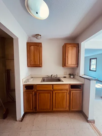 a kitchen with a sink and cabinets