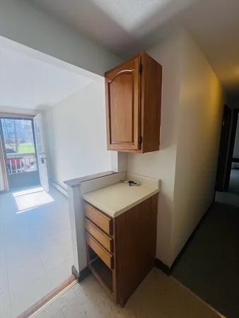 a utility room with a sink a vanity and a mirror