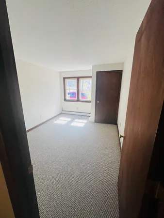 view of room with window and refrigerator