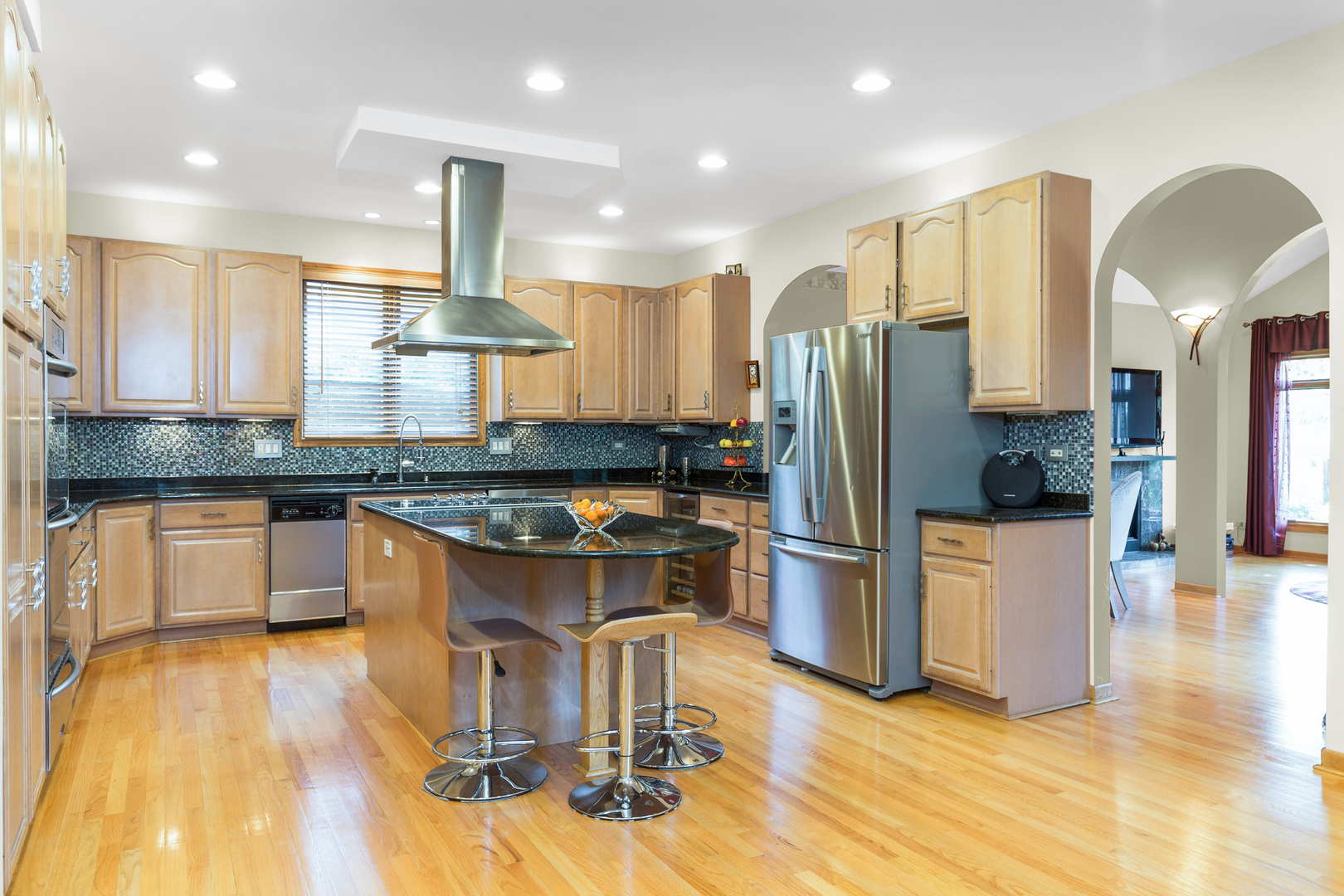 1050 Ridge Road Highland Park, IL 60035 - Photo 4 of 33 a kitchen with stainless steel appliances granite countertop a refrigerator a stove and a wooden floors