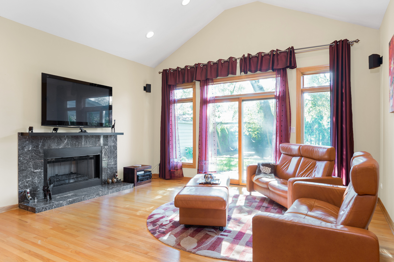 1050 Ridge Road Highland Park, IL 60035 - Photo 9 of 33 a living room with furniture a fireplace and a flat screen tv