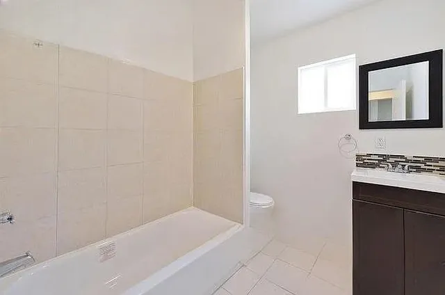 a bathroom with a bathtub and a sink