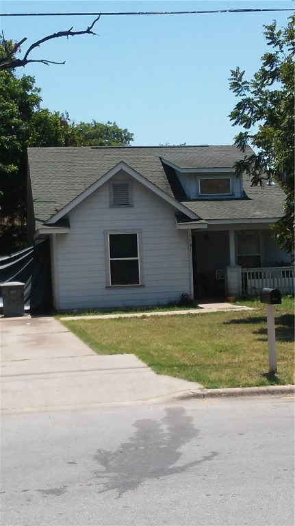 1141 Gunter Street Austin, TX 78721 - Photo 1 of 1 a front view of a house with a yard and garage