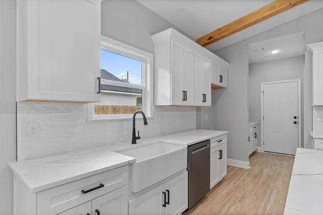 a kitchen with a sink a stove and cabinets