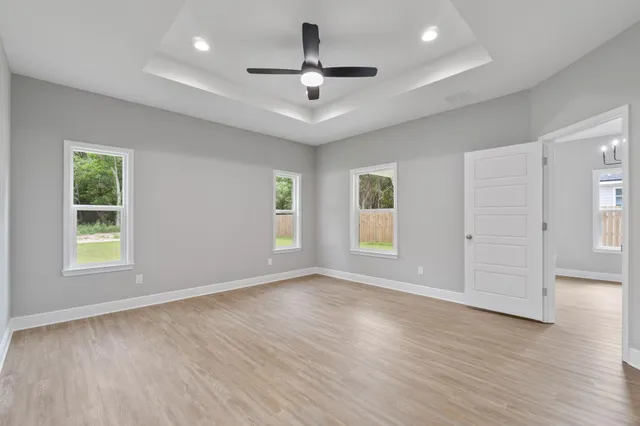 wooden floor in an empty room with a window