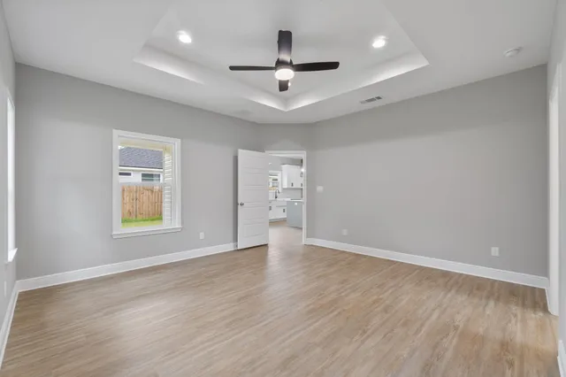 wooden floor in an empty room with a window