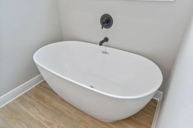 a white bath tub sitting in a bathroom