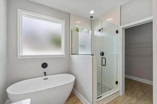 a bathroom with a tub and shower