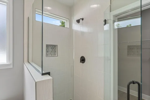 a bathroom with a shower and a mirror