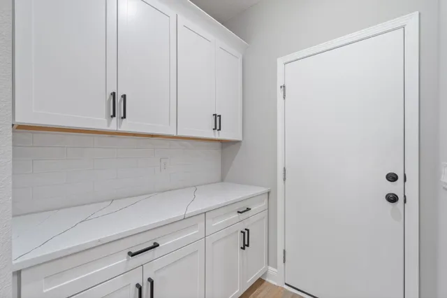 a view of storage and utility room with closet