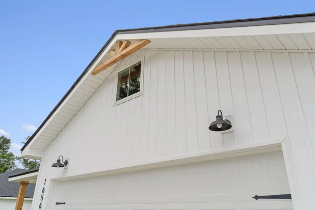 a view of a air conditioner and an empty room with a ceiling fan