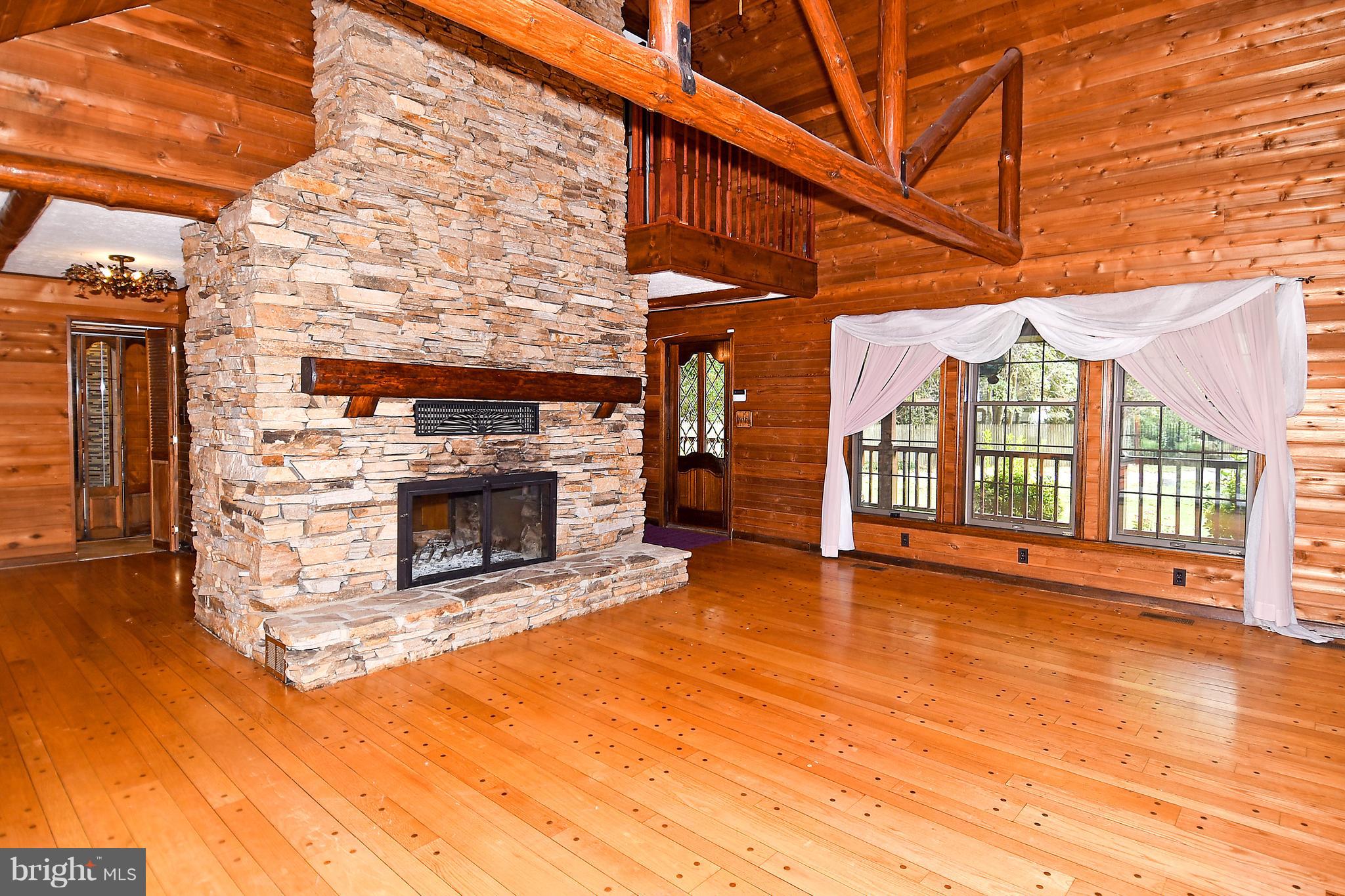 878 Sycamore Hill Road Severn, MD 21144 - Photo 10 of 29 FOYER ENTERS INTO LIV RM HAS WOOD BURN FRPL