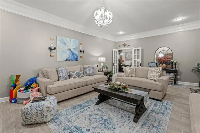 a view of a dining room with furniture a fireplace and a chandelier