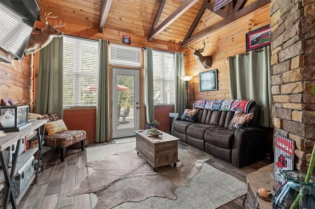 a view of a table and chairs on the deck in front of house