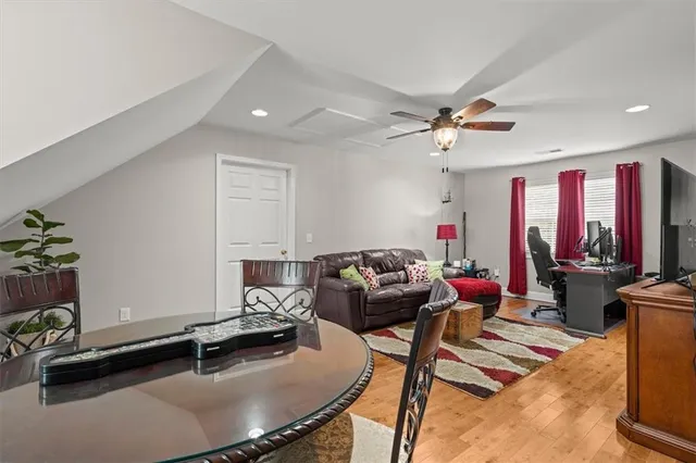 a view of a white house with a big yard and large trees