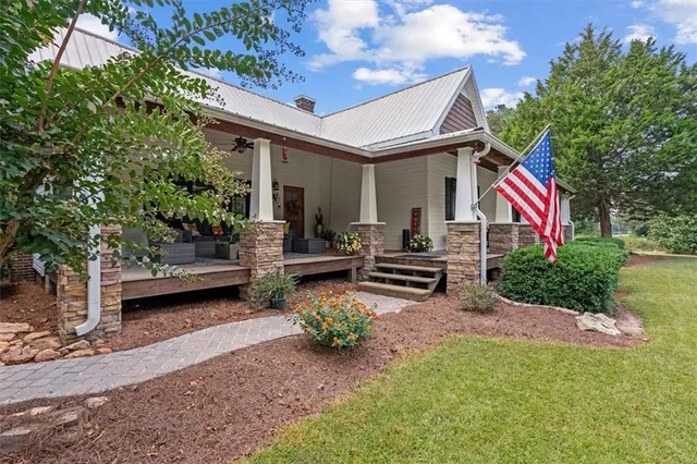a outdoor space with patio the couches and a dining table with the view of the house