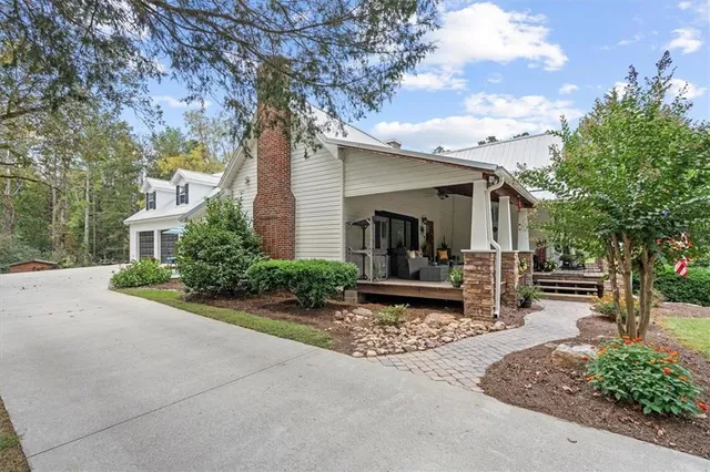 a view of a porch with furniture and garden