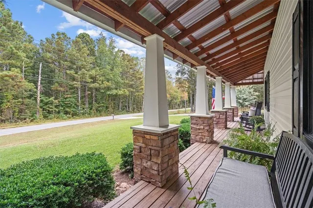 a view of a patio with table and chairs and potted plants