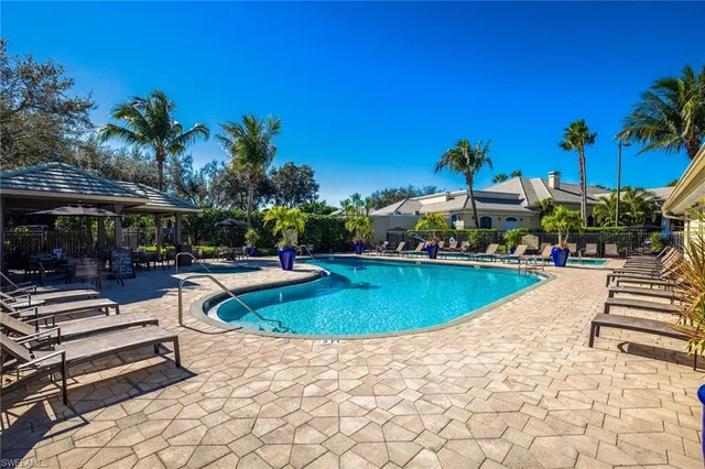 a view of a swimming pool with chairs
