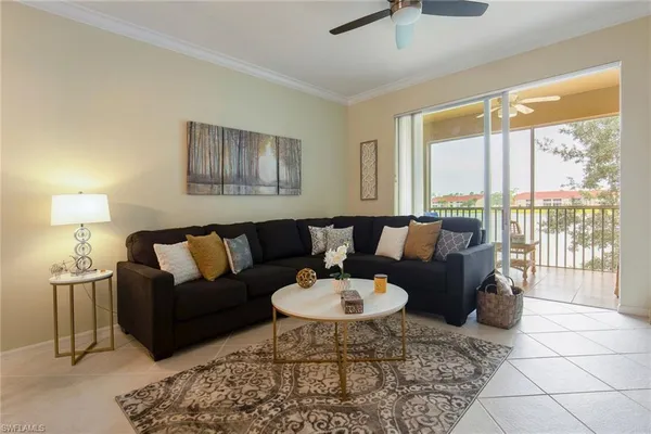 a living room with furniture and a lamp