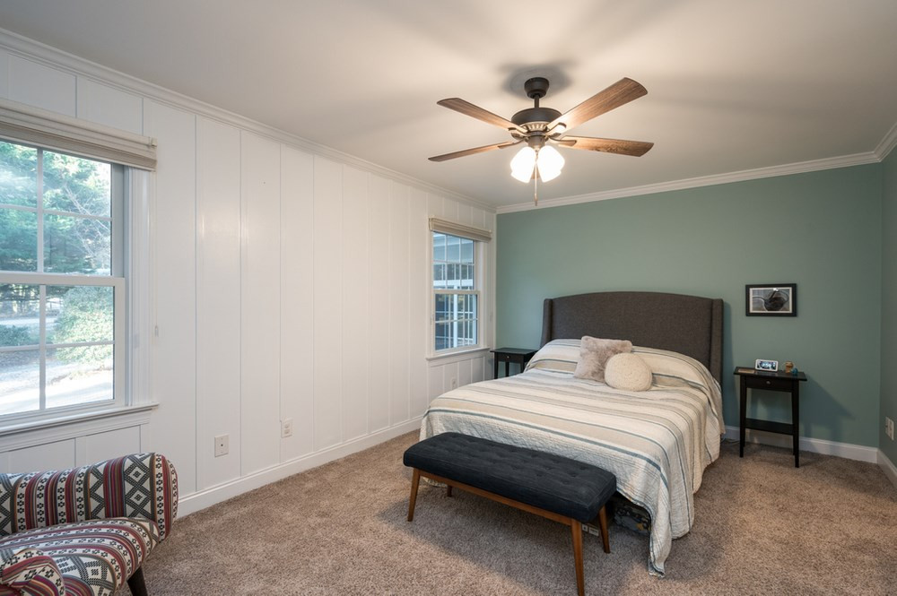 4709 Randolph Court Raleigh, NC 27606 - Photo 12 of 27 A nice size master bedroom features board and batten trim on a feature wall, custom roman window shades that provide privacy and a flow natural light,