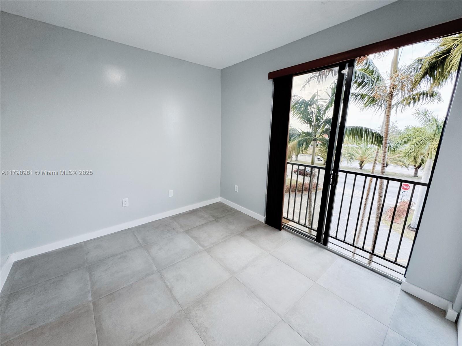 8440 Southwest 8th Street, Unit 304A Miami, FL 33144 - Photo 17 of 21 an empty room with windows
