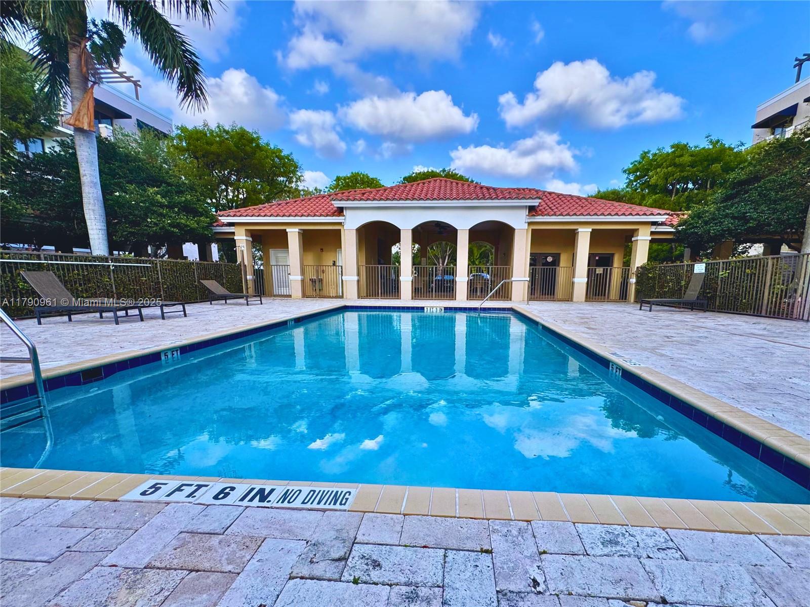8440 Southwest 8th Street, Unit 304A Miami, FL 33144 - Photo 19 of 21 a view of a house with swimming pool