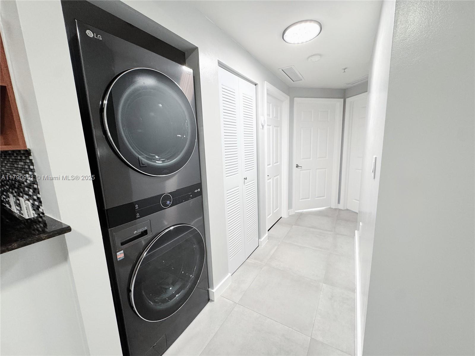 8440 Southwest 8th Street, Unit 304A Miami, FL 33144 - Photo 10 of 21 a view of a hallway with washer and dryer
