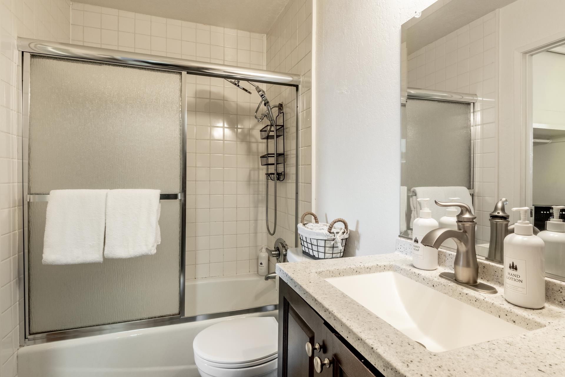 137 Laurel Mountain Road, Unit 312 Mammoth Lakes, CA 93546 - Photo 13 of 37 a bathroom with a granite countertop sink toilet and shower