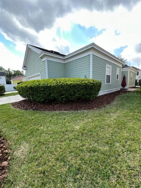 1005 Wiregrass Street Celebration, FL 34747 - Photo 13 of 31 a front view of a house with a garden