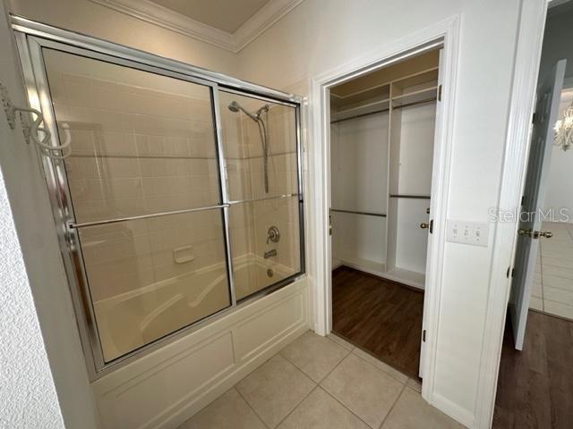 1005 Wiregrass Street Celebration, FL 34747 - Photo 18 of 31 a bathroom with a glass shower door
