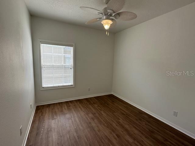 1005 Wiregrass Street Celebration, FL 34747 - Photo 20 of 31 an empty room with wooden floor fan and window