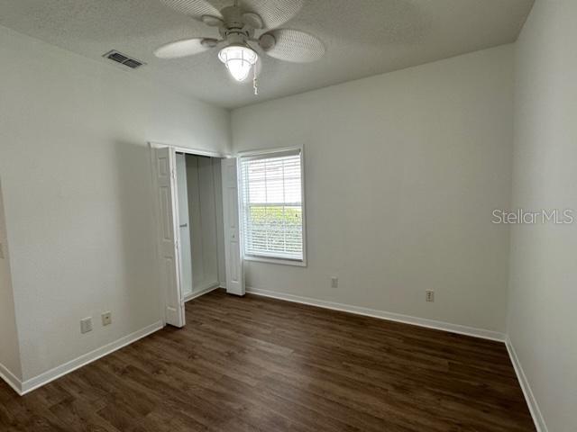 1005 Wiregrass Street Celebration, FL 34747 - Photo 26 of 31 an empty room with wooden floor and windows