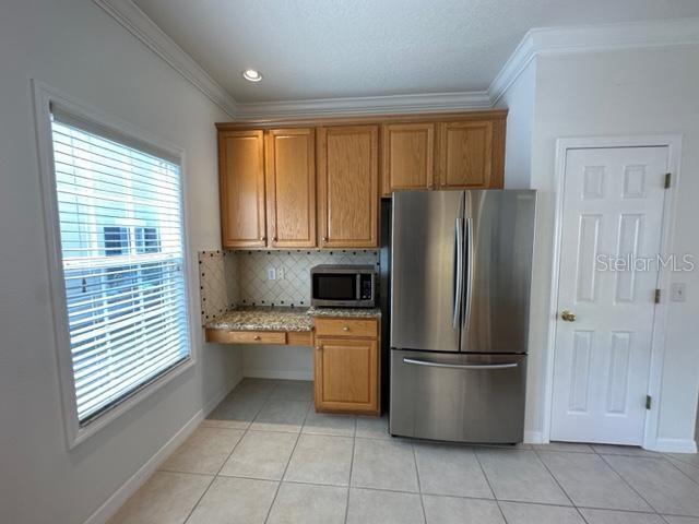 1005 Wiregrass Street Celebration, FL 34747 - Photo 10 of 31 a kitchen with stainless steel appliances granite countertop a refrigerator and a stove