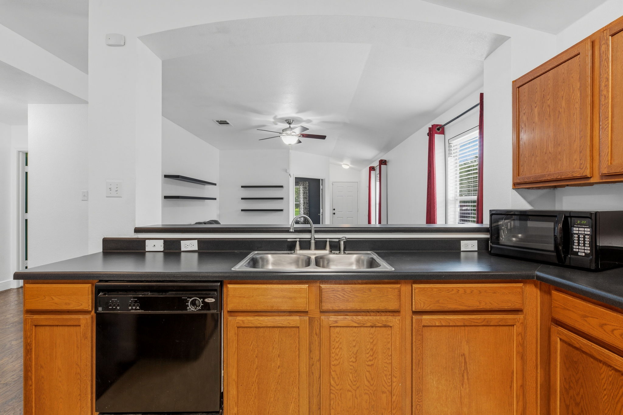 12601 Waynespur Lane Elgin, TX 78621 - Photo 22 of 38 A well-equipped kitchen offering ample counter space and a seamless connection to the living area.