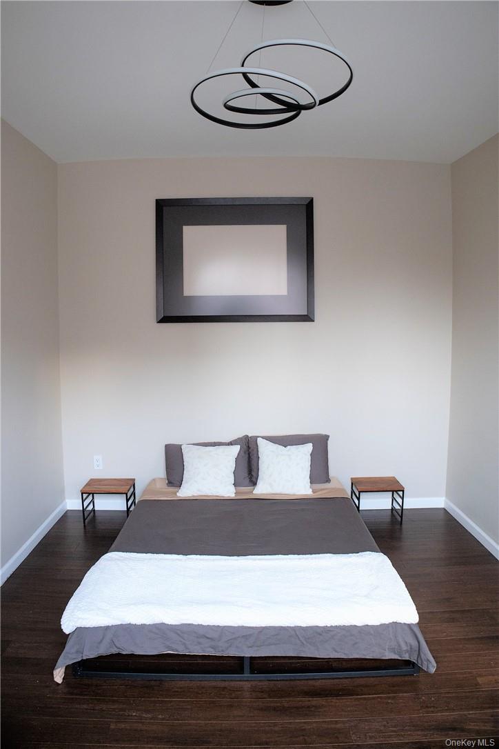 663 Locust Street, Unit 3G Mount Vernon, NY 10552 - Photo 9 of 13 a bedroom with a bed and a chandelier