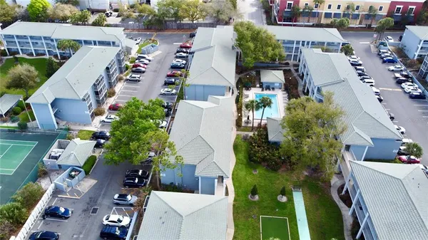 an aerial view of multiple houses with yard